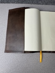 Handcrafted vintage-style brown leather journal with a bronze metal clasp.