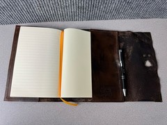 Handcrafted vintage-style brown leather journal with a bronze metal clasp.