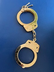 Smith and Wesson LEHMAN BROS. gold plated M100 handcuff.