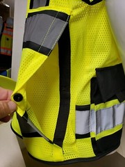 Safety green surveyor vest with tablet pocket.
