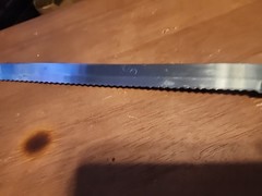 Russell International 12″ Slicer Knife Serrated High Carbon Steel White Handle