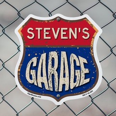 Steven’s Garage Shield Shaped Sign Weather Resistant Crafted in the USA