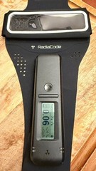 Radiacode 101 Gamma Radiation Detector Portable Dosimeter with green arm band.