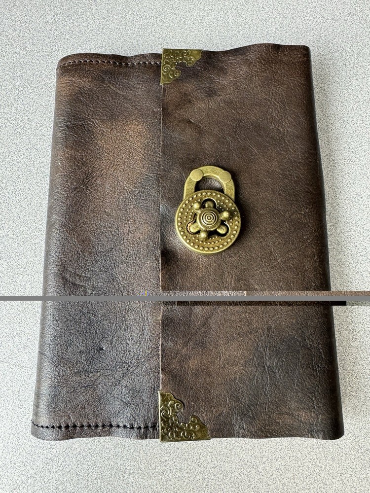 Handcrafted vintage-style brown leather journal with a bronze metal clasp.