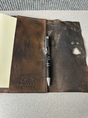 Handcrafted vintage-style brown leather journal with a bronze metal clasp.