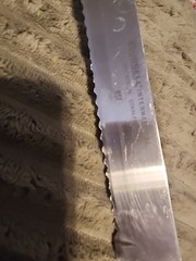 Russell International 12″ Slicer Knife Serrated High Carbon Steel White Handle