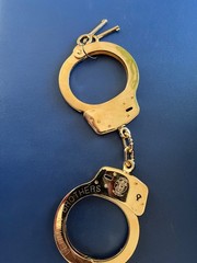 Smith and Wesson LEHMAN BROS. gold plated M100 handcuff.