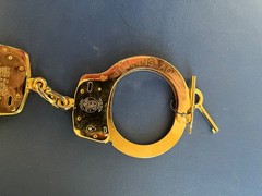 Smith and Wesson LEHMAN BROS. gold plated M100 handcuff.