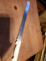 Russell International 12″ Slicer Knife Serrated High Carbon Steel White Handle