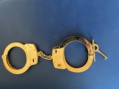 Smith and Wesson LEHMAN BROS. gold plated M100 handcuff.